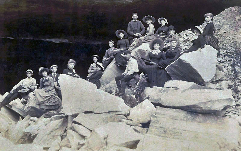 Crowd of people sitting on the rocks of a quarry
